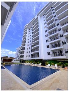 a large building with a swimming pool next to a building at Sakura Aqua Gardens in Mombasa