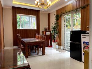 a kitchen with a table and a dining room at Villa Hotel Thao Nguyen in Da Lat