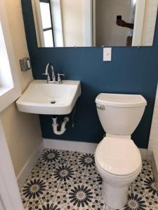 a bathroom with a white toilet and a sink at Pets Ok Steps 2 Ocean Center Walk 2 Beach in Daytona Beach