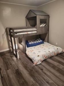 a bunk bed in a room with a wooden floor at 3 Bedroom Cozy Home Minutes From Tims Ford Lake in Winchester
