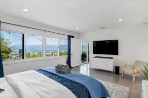 a bedroom with a bed and a flat screen tv at 4BR Hilltop Villa by Universal Studios with Pool and Amazing Views in Los Angeles