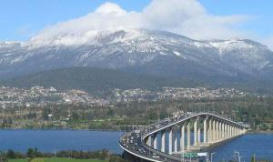 a bridge over a body of water with a mountain at The Cambridge in Warrane