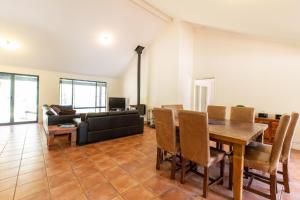 a living room with a table and a couch at Heavenly Hideaway Secluded Yallingup Escape in Yallingup
