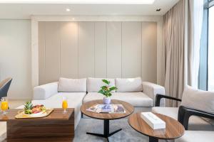 a living room with a couch and a table at Samaya Holiday Homes - Family Luxury Suites in Dubai