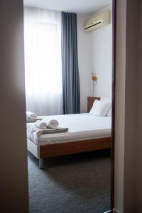 a bedroom with a bed and a window at Sea house Afrodita1-rooms in Nesebar +7 photos