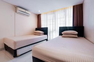 Postel nebo postele na pokoji v ubytování House Bandung City