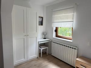 a white room with a desk and a window at Cherry Hill Loft in Plitvička Jezera