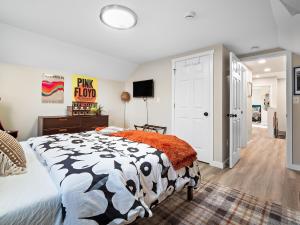 a bedroom with a black and white comforter on a bed at Arts District Walk to Restaurants, Bars Sleeps 8 -Tillman in Cleveland