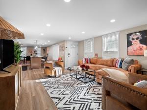 a living room with a couch and a table at Arts District Walk to Restaurants, Bars Sleeps 8 -Tillman in Cleveland