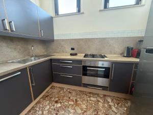 a kitchen with a sink and a stove at Casa Cervi in Gabicce Mare