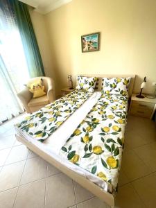 a large bed in a room with a bedspread on it at Amarena Studio Santa Marina, Sozopol in Sozopol +14 photos