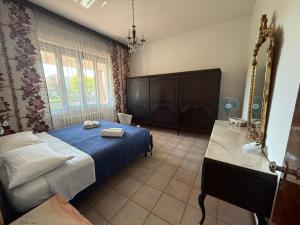 a bedroom with a blue bed and a mirror at Casa Cervi in Gabicce Mare +25 photos