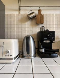 a kitchen counter with a coffee maker and a toaster at Maison charmante - 10 min de Paris in Montreuil