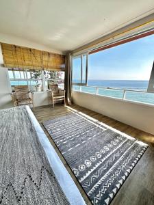 a bedroom with a view of the ocean at Beach front villa , All Mare 2 in Uluwatu