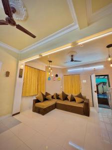 a living room with a couch in the middle at Swaransh villa in Lonavala