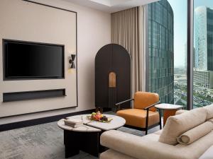 a living room with a couch and a tv at Anantara Downtown Dubai in Dubai