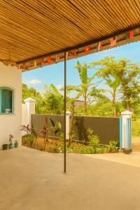 a building with a view of a garden with trees at Casa De' Summer Banyuwangi in Banyuwangi