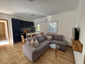 a living room with a couch and a table at Domky Slapy pod golfem in Slapy