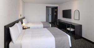 a hotel room with two beds and a television at Hotel President in Seoul