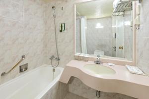 a bathroom with a sink and a bath tub and a mirror at Hotel President in Seoul +52 photos