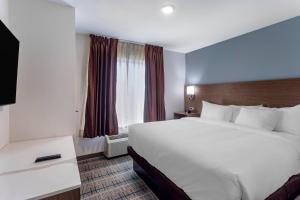 a hotel room with a large bed and a window at MainStay Suites Lebanon - Nashville Area in Lebanon +26 photos