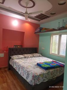 a bedroom with a bed in a room at Aru Homestay Hampi in New Hampi
