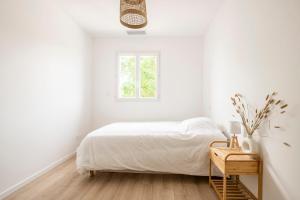 En eller flere senge i et værelse på Villa Bassin d'Arcachon