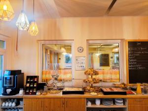 a restaurant with a counter with aasteryasteryasteryasteryasteryasteryasteryasteryastery at Schlafplatzl in Marchtrenk