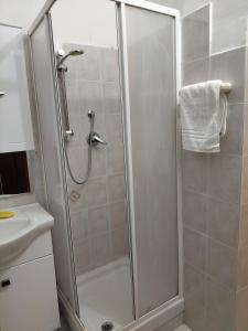 a bathroom with a shower and a sink at The Sun Apt in Trieste +10 photos