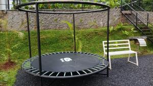 a black trampoline sitting next to a chair at Vythiri Windsor in Wayanad +8 photos