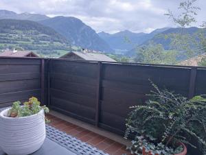 a balcony with a black fence and some plants at Appartement Margarethen in Vipiteno
