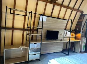 a bedroom with a bunk bed and a desk with a computer at Senara Resort Ciwidey in Baruhtunggul
