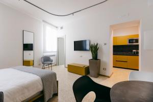 a bedroom with a bed and a table and a tv at Villa Turco Berti luxury apartments & SPA in Caldiero +43 photos