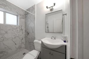 a bathroom with a sink and a toilet and a mirror at Peacock Villa 2 By Pmi in Fort Lauderdale +50 photos