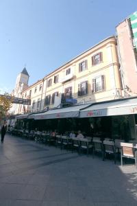 a group of tables and chairs in front of a building at Portal Villa Apartments in Bitola