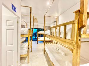 a room with several bunk beds and a doorway at Sunzal Surf Garden - El Tunco in Tamanique