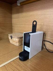 a computer with a cell phone sitting on top of it at Almeta Apartment 3 in Chios