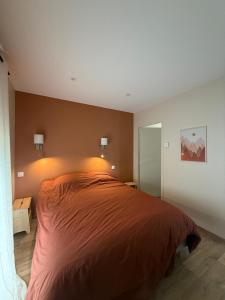 a bedroom with a large bed in a room at Gite Grand Confort en pleine nature - Le Perchoir de l'Olme in Chalmazel Jeansagniere