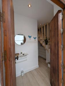 a hallway with a staircase and a mirror on the wall at Casa del Valle Encantado in Galaroza