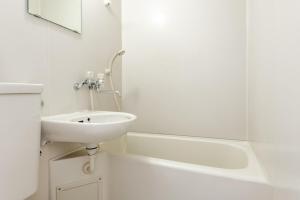 a white bathroom with a sink and a bath tub at アスピア305 Easy access to Shinjuku 1-minute walk from Koshinzuka Station in Tokyo +32 photos