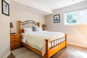 a bedroom with a large bed and a window at Quiet Area Near Downtown Walkable To Cafes in Maple Ridge District Municipality