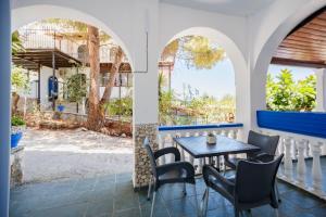 a table and chairs on the porch of a restaurant at Velendzas Holidays in Alikanas