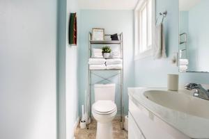 a bathroom with a white toilet and a sink at Quiet Area Near Downtown Walkable To Cafes in Maple Ridge District Municipality +35 photos
