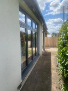 a window on the side of a house at Two double bedroom self contained Retreat in Thundersley