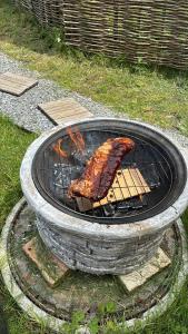 a piece of meat is cooking on a grill at Sacasa in Langenbruck