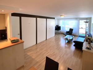 a large living room with a couch and a table at Adler 82 in Leukerbad