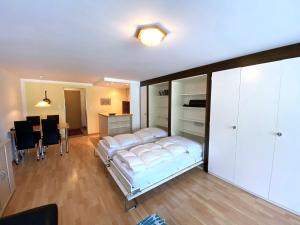 a bedroom with a bed and a dining room at Adler 82 in Leukerbad
