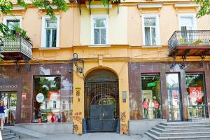 a building on a street with a store at Apartment Deribasovskaya with jacuzzi in Odesa