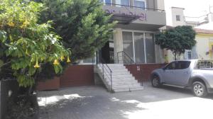 a small blue car parked in front of a building at Feevos in Piraeus