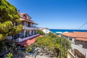 a view of a building with the ocean in the background at Velendzas Holidays in Alikanas